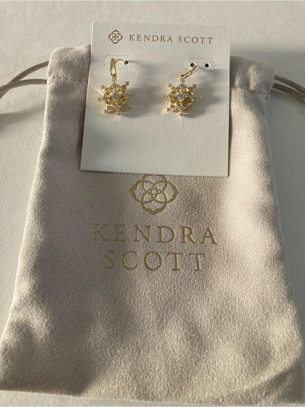 Kendra Scott snowflake crystal drop earrings in gold with white crystals